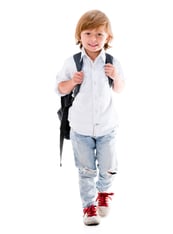 Happy boy walking to school - isolated over a white background